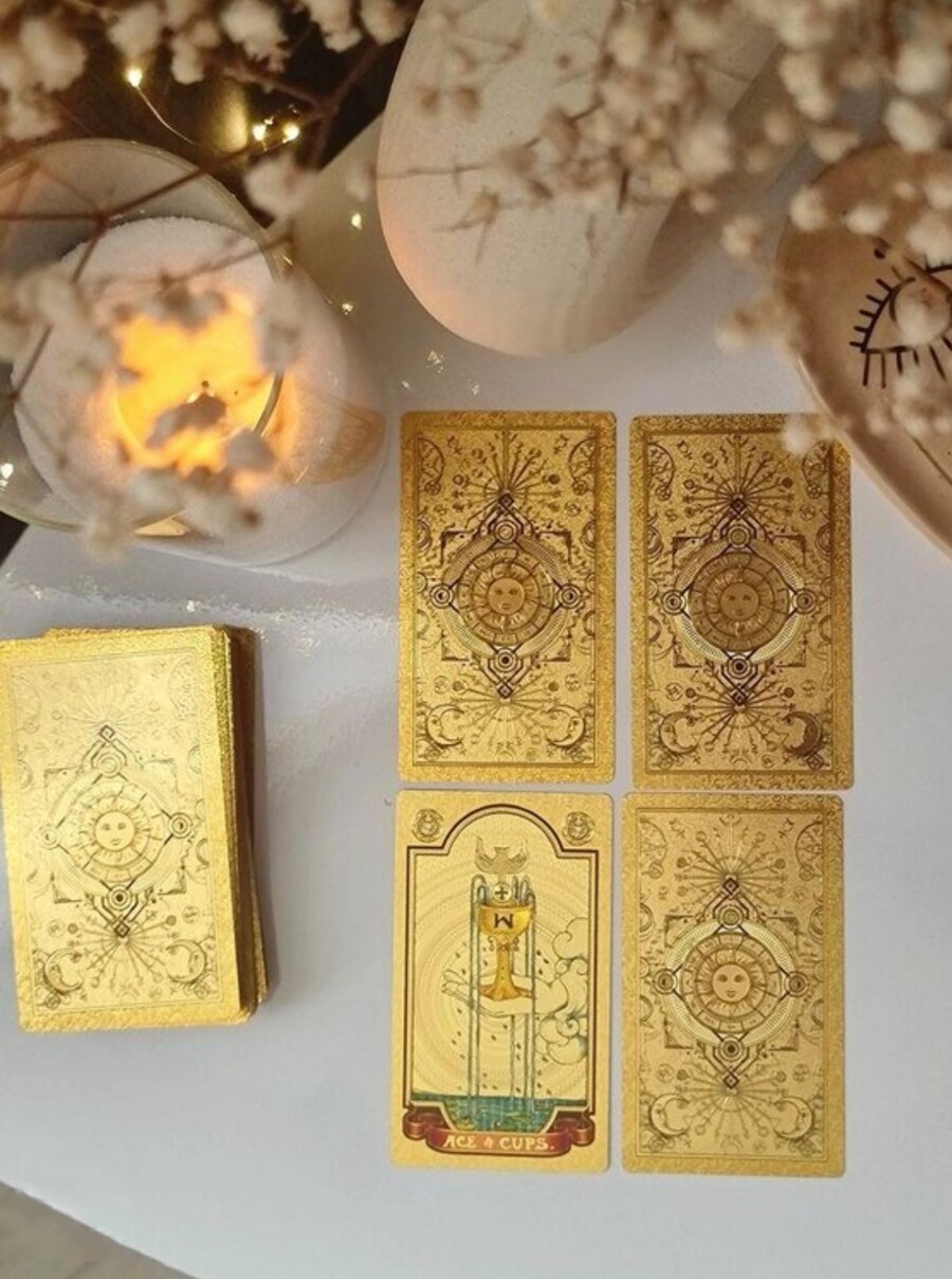 Ace of Cups tarot cards with candles